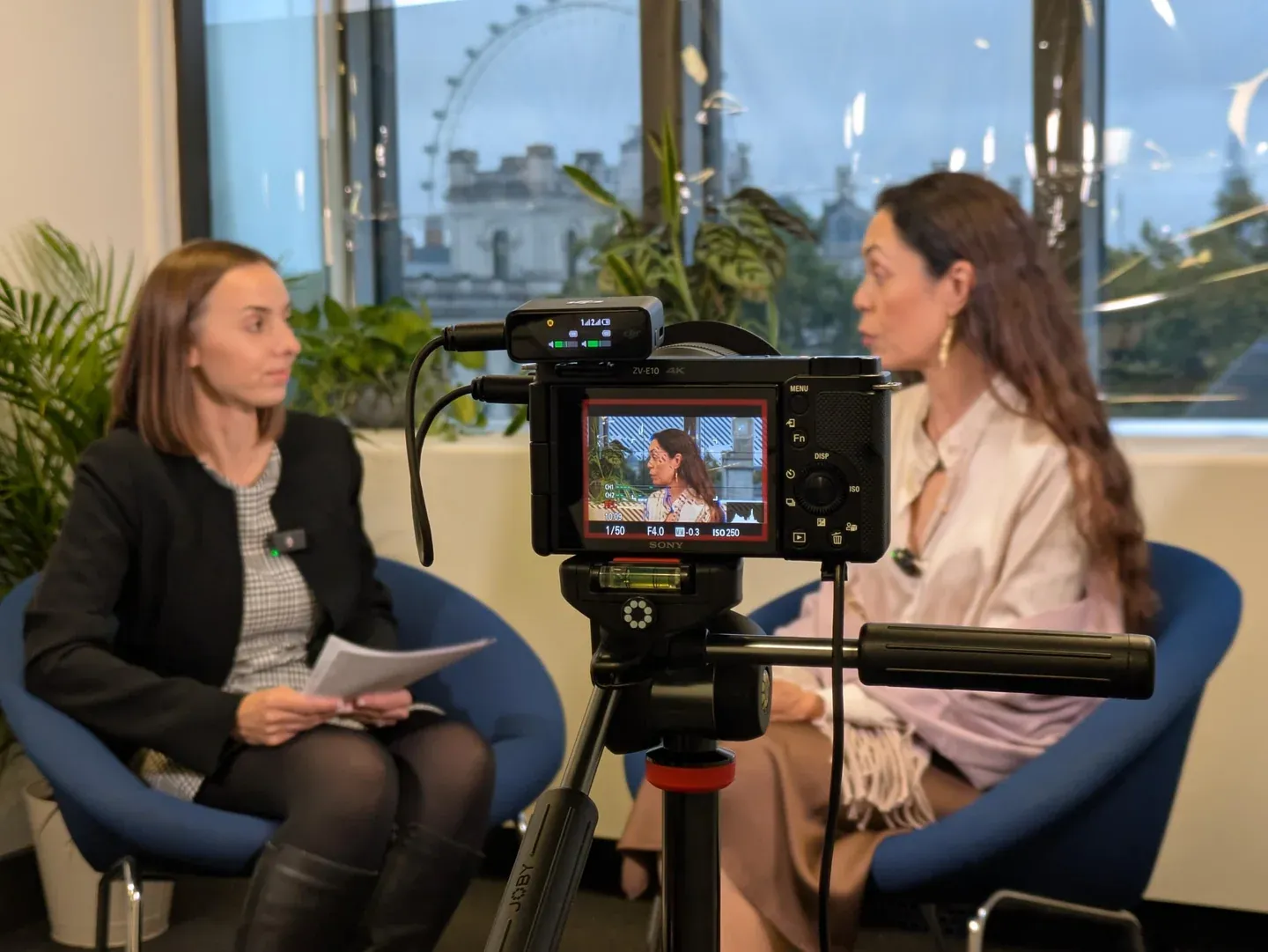 The production camera and monitor capture an IPR conversation in the summit recording space.