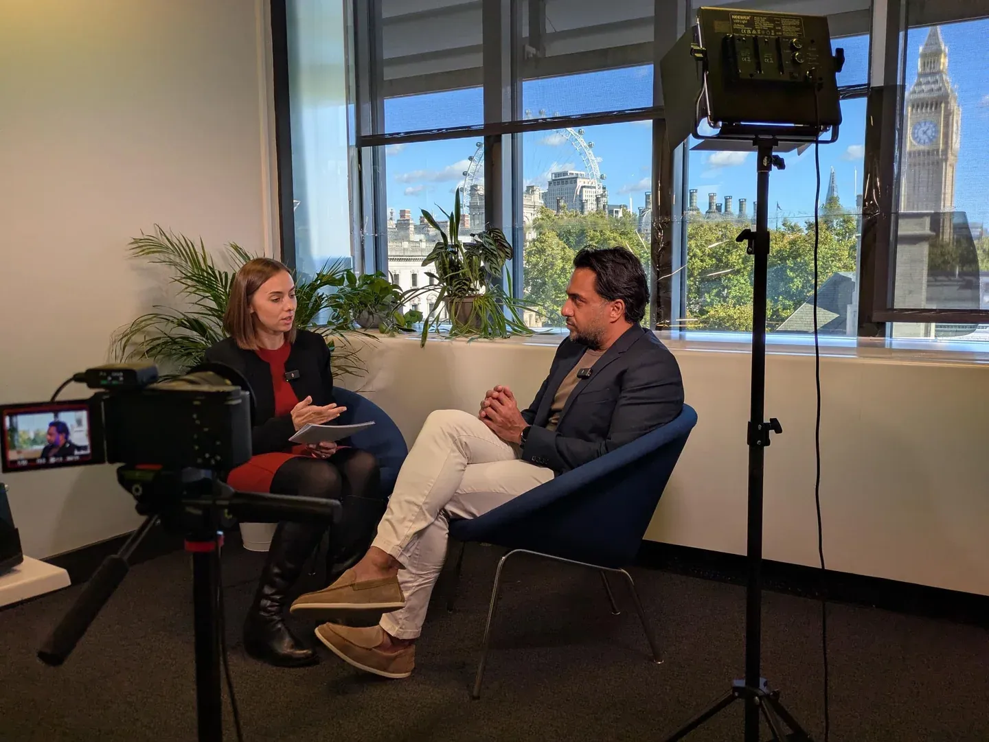 An IPR interview in progress at IAMTN Summit: camera, lighting and two seated speakers against the Westminster backdrop.
