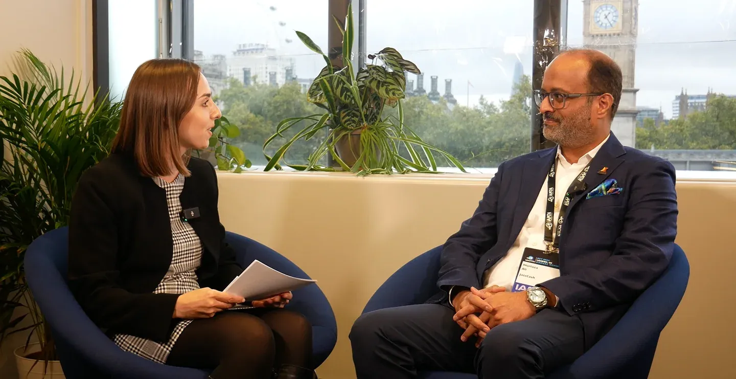 Murtaza Ali in a host-led IPR interview at IAMTN Summit 2026, with Westminster visible behind the speakers.